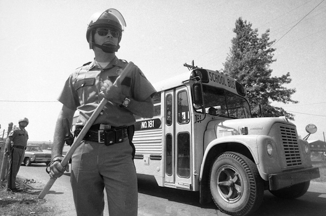A Kentucky State trooper stands outside of Southern High School in 1975.