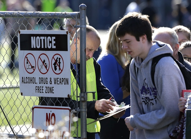 School and other officials check names and release students to parents at a gate at North Thurston High School Monday, April 27, 2015, after a shooting at the school earlier in the morning.