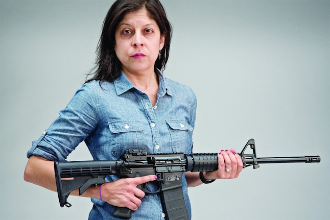 Helen Ubiñas poses with the AR-15 gun she bought in seven minutes. This is the same gun used in the Orlando massacre that is legally sold across the country.